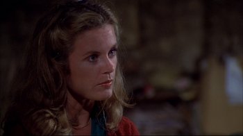 Movie still from “Piranha” (1978), directed by Joe Dante – A person with long hair; Close Up shot, High angle