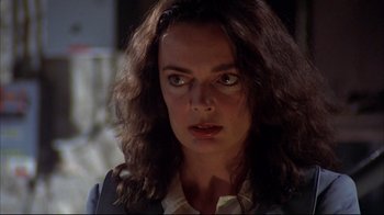 Movie still from “Piranha” (1978), directed by Joe Dante – A person with long curly hair; Close Up shot, Low angle