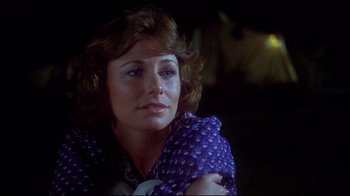 Movie still from “Piranha” (1978), directed by Joe Dante – A person sitting down with her arms crossed; Close Up shot, Over the shoulder angle