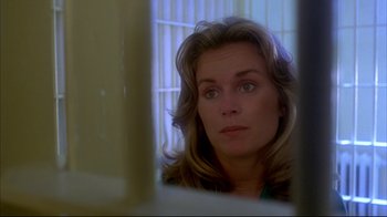 Movie still from “Piranha” (1978), directed by Joe Dante – A person looking at a mirror; Close Up shot, Over the shoulder angle