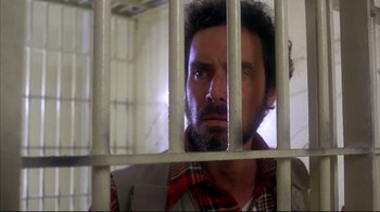 Movie still from “Piranha” (1978), directed by Joe Dante – A man in a jail cell with his eyes wide open; Close Up shot, Low angle