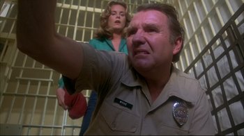 Movie still from “Piranha” (1978), directed by Joe Dante – A man and a woman in a jail cell; Medium shot, Low angle