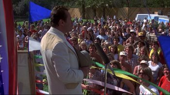 Movie still from “Piranha” (1978), directed by Joe Dante – A crowd of people are gathered around a microphone; Wide shot, High angle