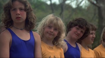 Movie still from “Piranha” (1978), directed by Joe Dante – A group of young girls standing next to each other; Close Up shot, Low angle