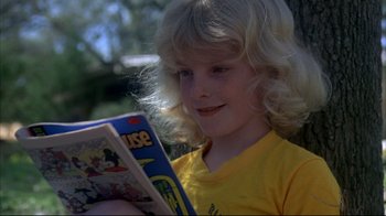 Movie still from “Piranha” (1978), directed by Joe Dante – A young girl is reading a comic book; Close Up shot, Low angle