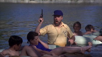 Movie still from “Piranha” (1978), directed by Joe Dante – A group of people on a raft in the water; Medium shot, Low angle