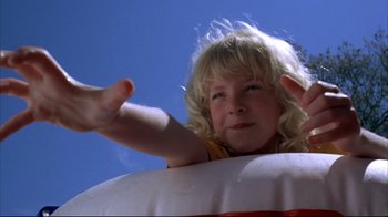 Movie still from “Piranha” (1978), directed by Joe Dante – A young blonde haired girl in a life preserver; Close Up shot, Low angle