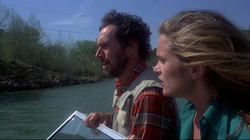 Movie still from “Piranha” (1978), directed by Joe Dante – A man and a woman looking at something on a tablet; Close Up shot, Low angle