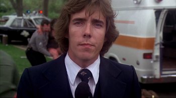 Movie still from “Piranha” (1978), directed by Joe Dante – A person wearing a suit and tie; Close Up shot, Low angle