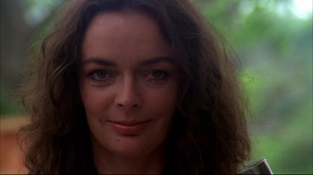 Movie still from “Piranha” (1978), directed by Joe Dante – A woman's face in a wooded area; Close Up shot, Low angle
