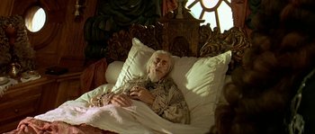 Movie still from “Pirates” (1986), directed by Roman Polanski – An old man laying in a bed with pillows on it; Medium shot, High angle