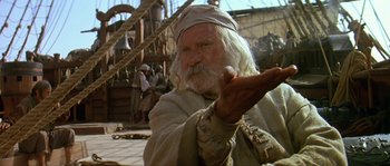 Movie still from “Pirates” (1986), directed by Roman Polanski – An old man with long white hair and a long white beard; Medium shot, Over the shoulder angle