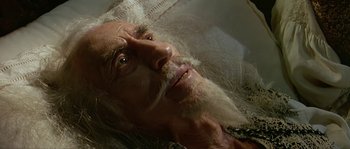 Movie still from “Pirates” (1986), directed by Roman Polanski – An old man with long white beard laying in a tub; Close Up shot, High angle