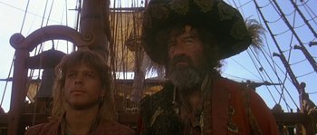 Movie still from “Pirates” (1986), directed by Roman Polanski – An older man with a beard and a hat; Medium shot, Over the shoulder angle