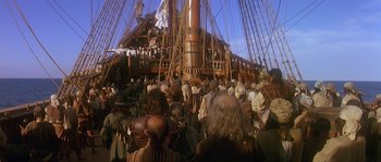 Movie still from “Pirates” (1986), directed by Roman Polanski – A crowd of people standing around a boat; Wide shot, High angle