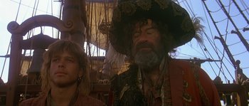 Movie still from “Pirates” (1986), directed by Roman Polanski – An older man with a beard and a hat; Medium shot, Over the shoulder angle