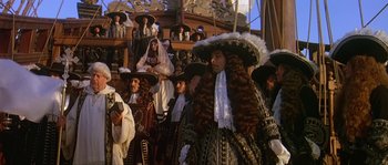 Movie still from “Pirates” (1986), directed by Roman Polanski – A group of people dressed up in costumes and hats; Medium shot, Low angle
