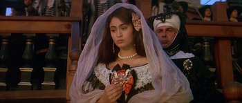 Movie still from “Pirates” (1986), directed by Roman Polanski – A woman in a white dress holding a heart; Close Up shot, High angle