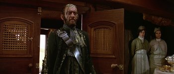 Movie still from “Pirates” (1986), directed by Roman Polanski – A man in a suit with a lot of dirt on his face; Medium shot, Low angle