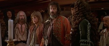 Movie still from “Pirates” (1986), directed by Roman Polanski – A group of men standing next to each other; Medium shot, Over the shoulder angle