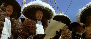 Movie still from “Pirates” (1986), directed by Roman Polanski – A man in a hat and costume holding a sheet of paper; Close Up shot, Low angle