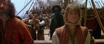 Movie still from “Pirates” (1986), directed by Roman Polanski – A group of people standing on top of a boat; Medium shot, Low angle