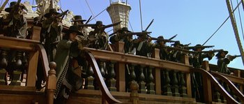 Movie still from “Pirates” (1986), directed by Roman Polanski – A group of men standing on top of a wooden deck; Wide shot, Low angle