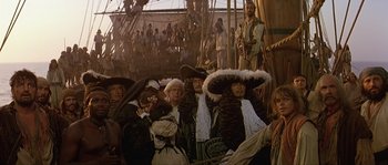 Movie still from “Pirates” (1986), directed by Roman Polanski – A group of people wearing hats on top of a boat; Wide shot, High angle