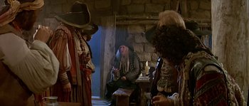 Movie still from “Pirates” (1986), directed by Roman Polanski – A group of people dressed as pirates in a room; Medium shot, Over the shoulder angle