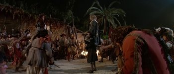 Movie still from “Pirates” (1986), directed by Roman Polanski – A group of people standing in a field at night; Wide shot, Over the shoulder angle