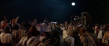 Movie still from “Pirates” (1986), directed by Roman Polanski – A group of people standing in front of a crowd; Wide shot, High angle