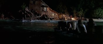 Movie still from “Pirates” (1986), directed by Roman Polanski – A man is sitting in a boat in the middle of the night; Extreme Wide shot, High angle