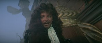Movie still from “Pirates” (1986), directed by Roman Polanski – A person wearing a wig with long hair; Close Up shot, Low angle