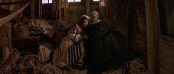 Movie still from “Pirates” (1986), directed by Roman Polanski – Two women dressed in medieval clothing sitting on a couch; Wide shot, High angle