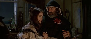 Movie still from “Pirates” (1986), directed by Roman Polanski – A man and a woman dressed in medieval garb; Medium shot, Over the shoulder angle