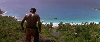Movie still from “Pirates” (1986), directed by Roman Polanski – A man standing on top of a hill looking at the ocean; Extreme Wide shot, High angle