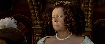 Movie still from “Pirates” (1986), directed by Roman Polanski – An older woman wearing a tiara and pearls; Close Up shot, Low angle