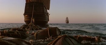 Movie still from “Pirates” (1986), directed by Roman Polanski – A boat in the water near the shore; Extreme Wide shot, Low angle