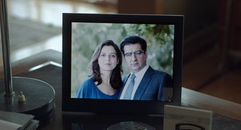 Movie still from “Pity” (2018), directed by Babis Makridis – A picture of a man and a woman on a television screen; Extreme Close Up shot, Low angle