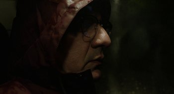 Movie still from “Pity” (2018), directed by Babis Makridis – A person wearing glasses and a helmet; Close Up shot, Low angle