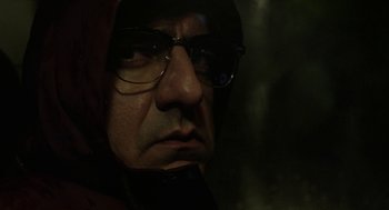 Movie still from “Pity” (2018), directed by Babis Makridis – A person wearing glasses and a hood; Close Up shot, Low angle