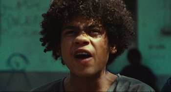 Movie still from “Pixote” (1980), directed by Hector Babenco – A person with curly hair; Close Up shot, Low angle