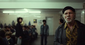 Movie still from “Pixote” (1980), directed by Hector Babenco – A group of people standing in a room; Medium shot, Over the shoulder angle