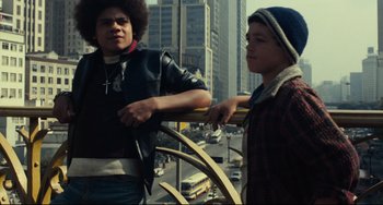 Movie still from “Pixote” (1980), directed by Hector Babenco – Two young men standing next to each other on a bridge; Medium shot, Low angle