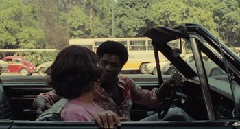 Movie still from “Pixote” (1980), directed by Hector Babenco – Two people in a car looking at each other; Medium shot, Over the shoulder angle
