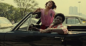 Movie still from “Pixote” (1980), directed by Hector Babenco – A man and a woman sitting in the back seat of a car; Medium shot, Low angle