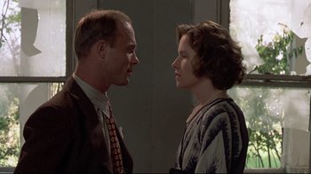 Movie still from “Places in the Heart” (1984), directed by Robert Benton – A man and a woman standing next to each other; Close Up shot, Low angle