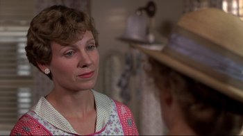 Movie still from “Places in the Heart” (1984), directed by Robert Benton – A woman wearing a hat looking at another woman in front of a mirror; Close Up shot, Over the shoulder angle