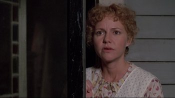 Movie still from “Places in the Heart” (1984), directed by Robert Benton – A person standing next to a door; Close Up shot, Over the shoulder angle