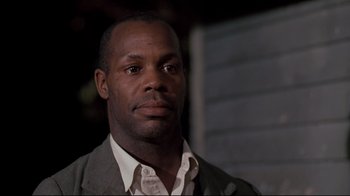 Movie still from “Places in the Heart” (1984), directed by Robert Benton – A person wearing a suit and tie; Close Up shot, Low angle